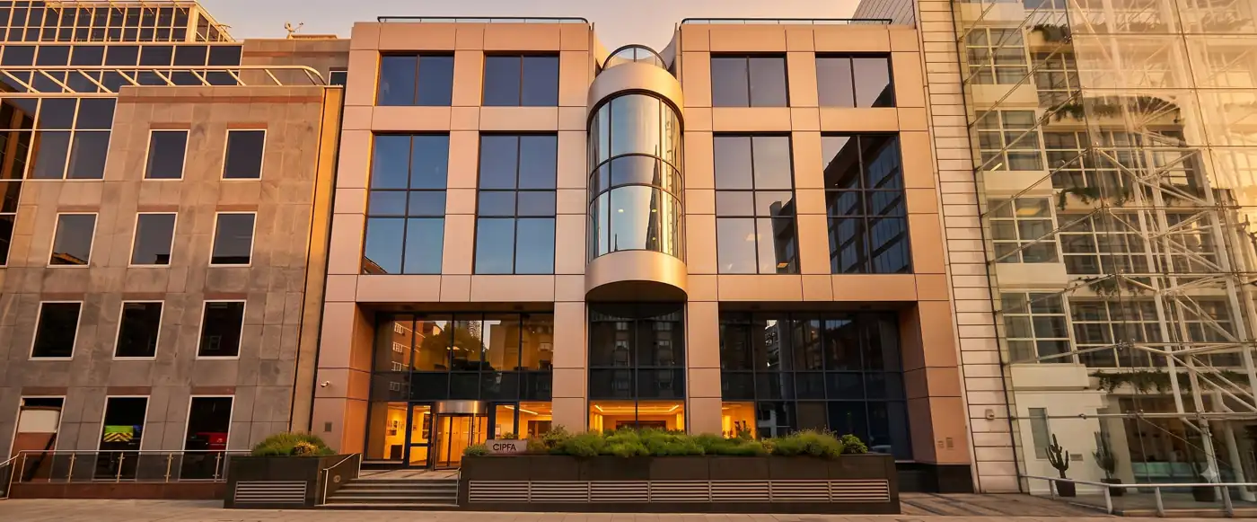 Front elevation of 77 Mansell Street, London, with its curved glass bay at golden hour
